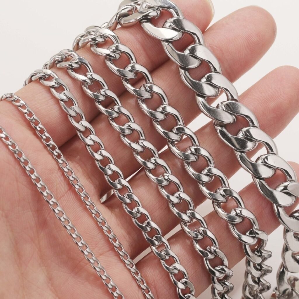 Flat and open NK chains in multiple widths displayed on a hand